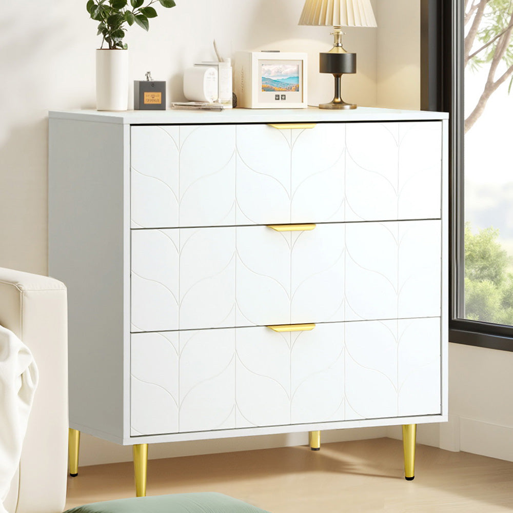 White dresser with gold legs in a room setting