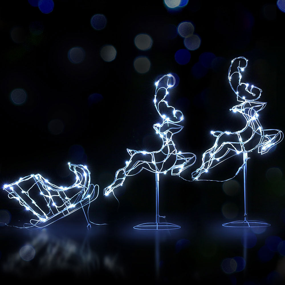 Decorative LED lights shaped like a sleigh, reindeer, and sleigh bells on a dark background.