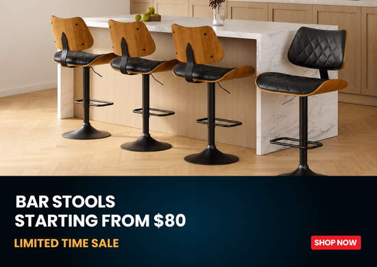 Four modern bar stools with black leather seats and light wood curved backs are arranged in front of a white marble kitchen island. A dark blue banner at the bottom reads 'BAR STOOLS STARTING FROM $80 LIMITED TIME SALE' with a red 'SHOP NOW' button.