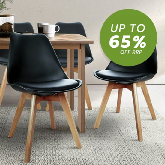Black molded dining chairs with light wood legs arranged around a wooden table on a patterned rug, with a green promotional badge reading 'UP TO 65% OFF RRP'.