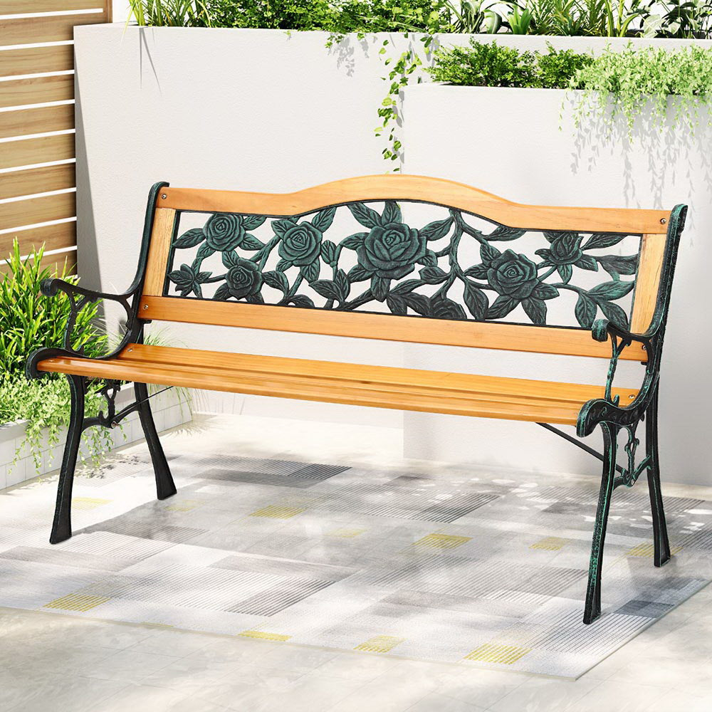 Wooden bench with floral designs on a patio