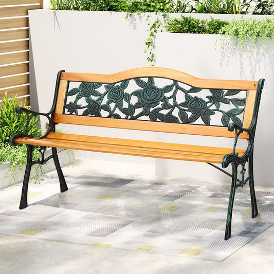 Wooden bench with floral designs on a patio