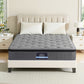 Gray mattress on a bed with a beige headboard in a bedroom setting