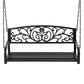 Decorative black metal swing with intricate designs on a white background