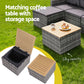 Outdoor furniture set with a matching coffee table and storage space on grass.