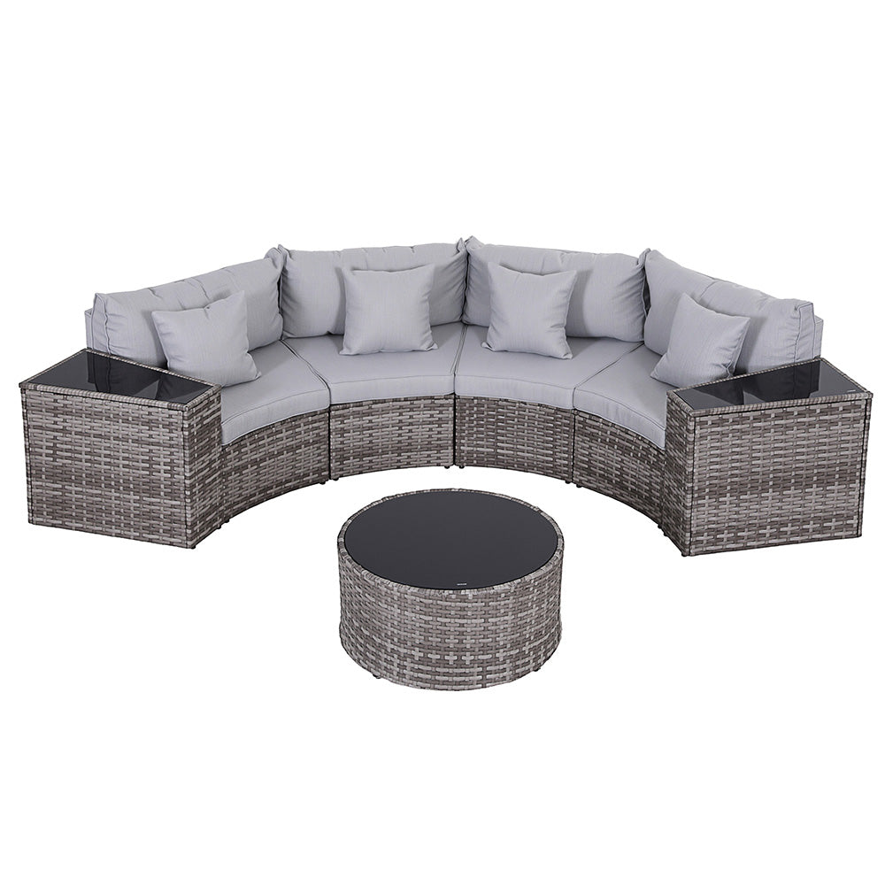 Outdoor patio furniture set with gray cushions and a round table on a white background
