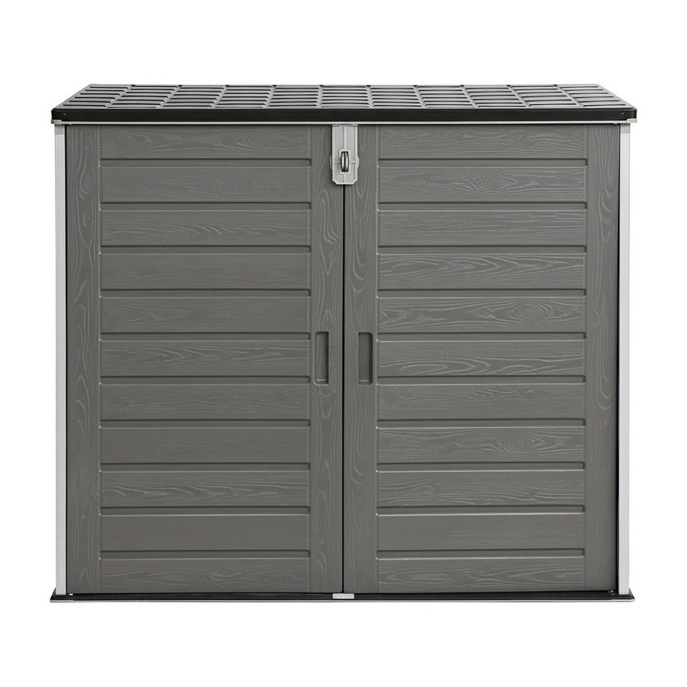 Gray outdoor storage shed with a slatted roof on a white background