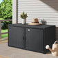 Black outdoor storage box with a hat and plant on a patio