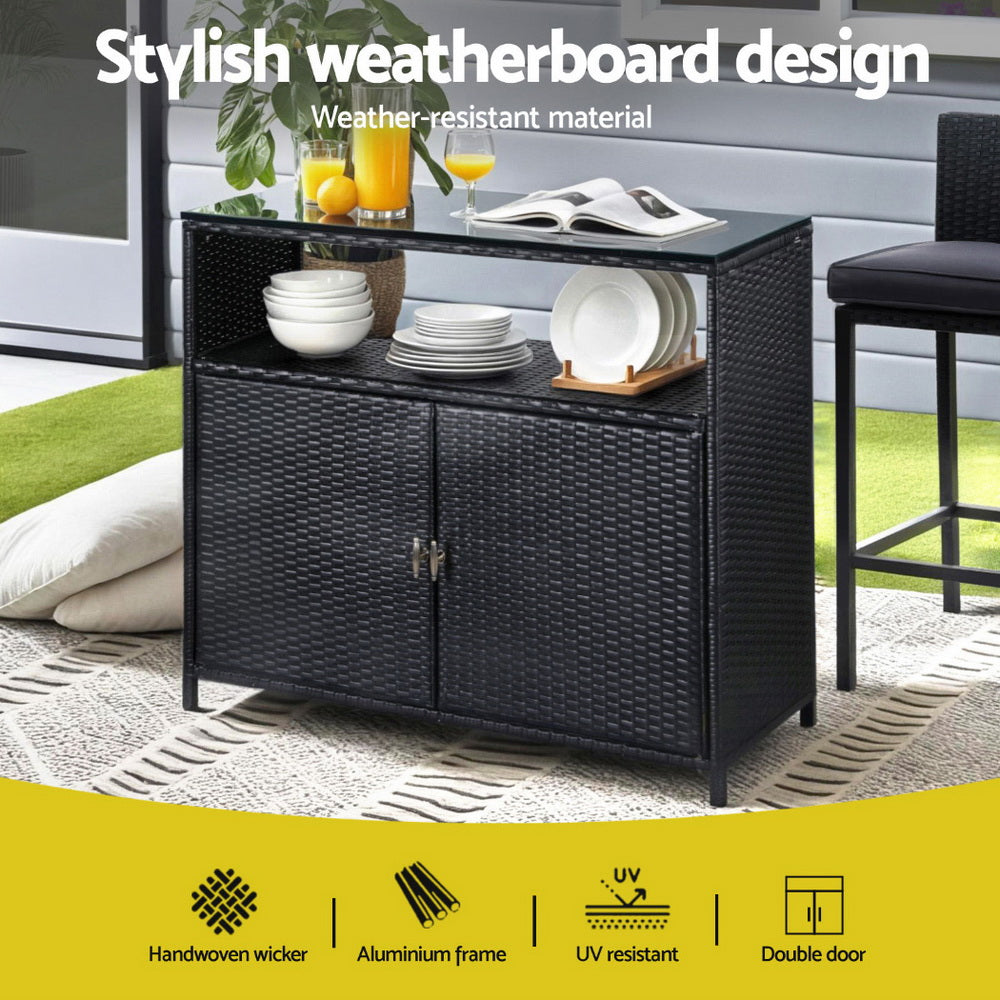 Outdoor furniture with weather-resistant material, including a black wicker sideboard.
