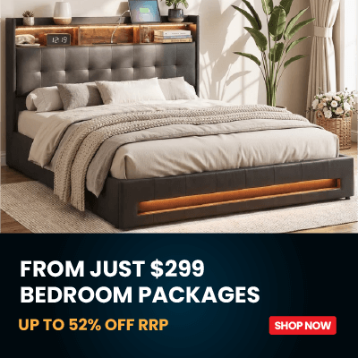 A bed with a dark tufted upholstered headboard and matching footboard, styled with beige bedding and a textured throw blanket in a bright bedroom. A dark promotional banner at the bottom reads 'FROM JUST $299 BEDROOM PACKAGES UP TO 52% OFF RRP' with a red 'SHOP NOW' button.