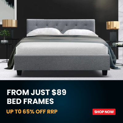 A gray upholstered bed frame with a tufted headboard, shown in a modern bedroom setting with white bedding and dark walls. A dark promotional banner at the bottom reads 'FROM JUST $89 BED FRAMES UP TO 65% OFF RRP' with a red 'SHOP NOW' button.